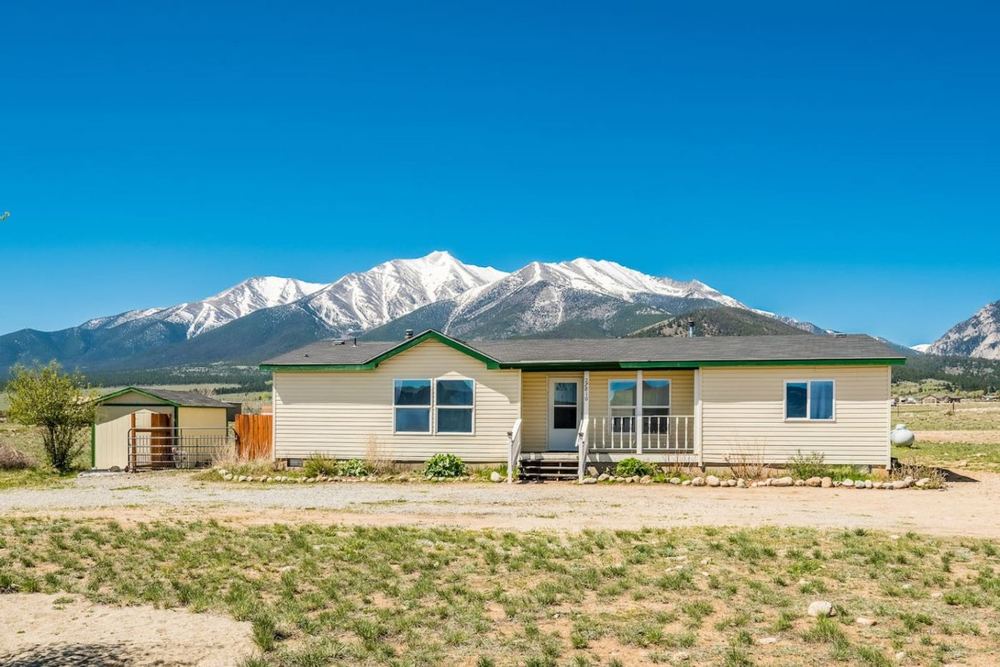 Short-term rental home with the Collegiate Peaks behind it near Buena Vista, Colorado